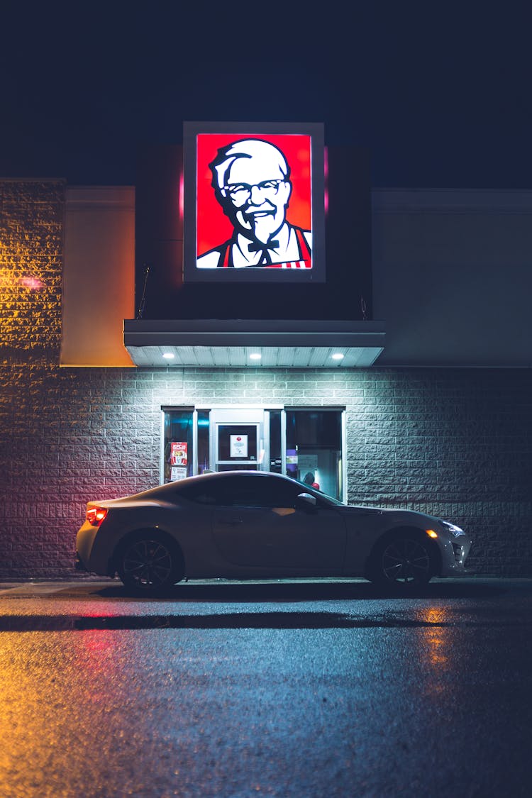 Shiny Car At Drive Through Cafe At Night