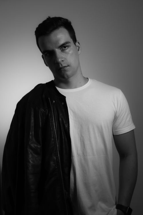 Free Stylish black and white portrait of a man wearing a leather jacket in a studio setting. Stock Photo