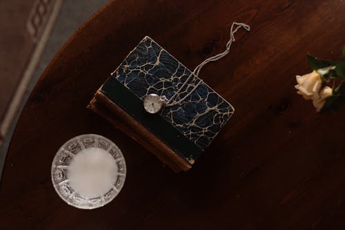 Old Pocket Watch on Top of an Old Book