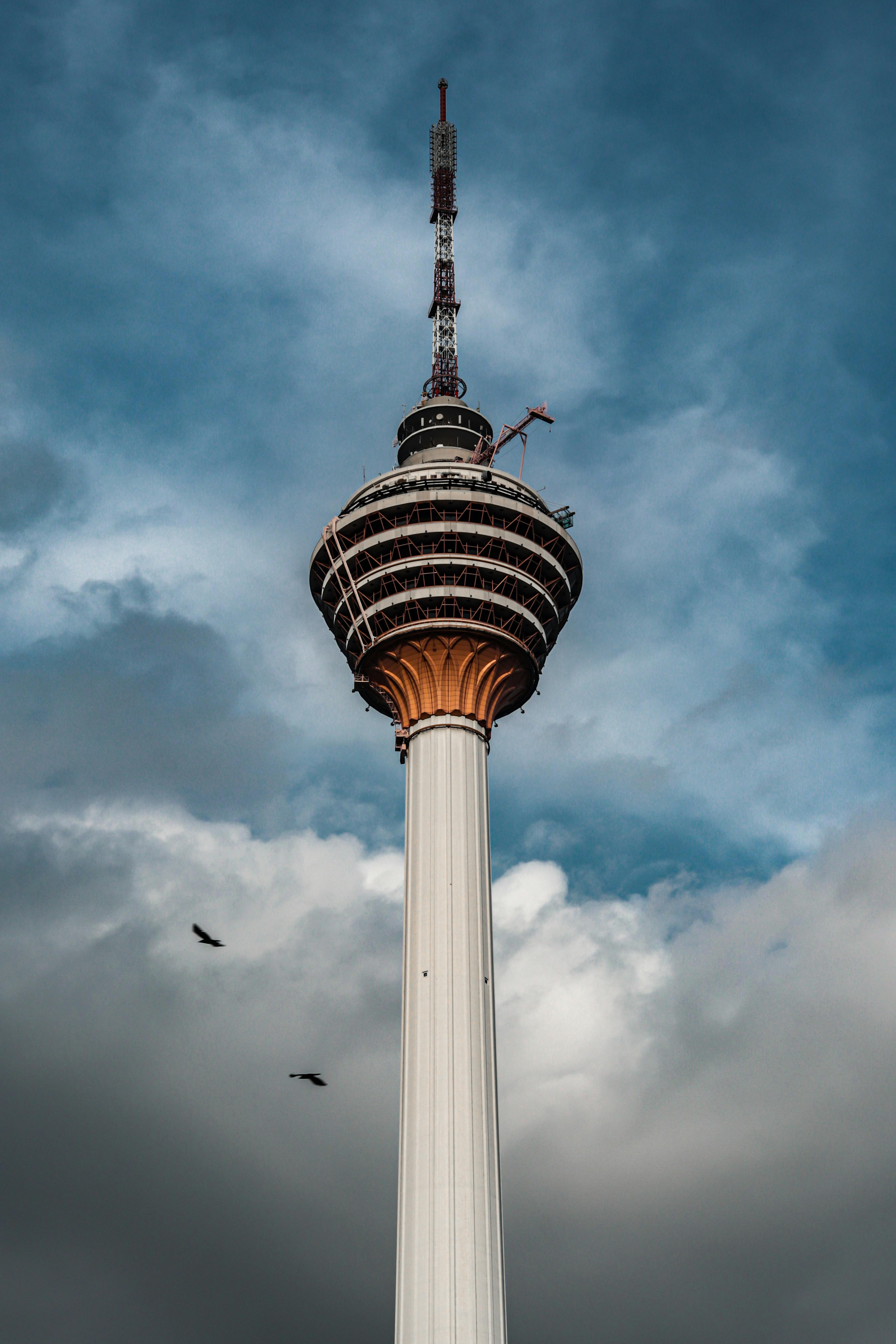 Free Low-Angle Shot of a Tower Under Cloudy Sky Stock Photo