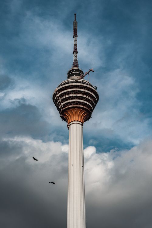 Free Low-Angle Shot of a Tower Under Cloudy Sky Stock Photo