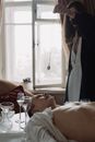 Woman in White Dress Lying on Bed