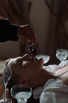 A dramatic scene of a man with grapes in luxurious setting, evoking hedonism and sophistication.