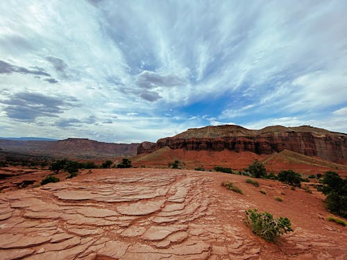 Brown Rocky Mountain Under White Clouds