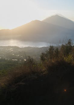 Beautiful sunrise view of a mountain landscape with a misty lake, offering tranquility and natural beauty.
