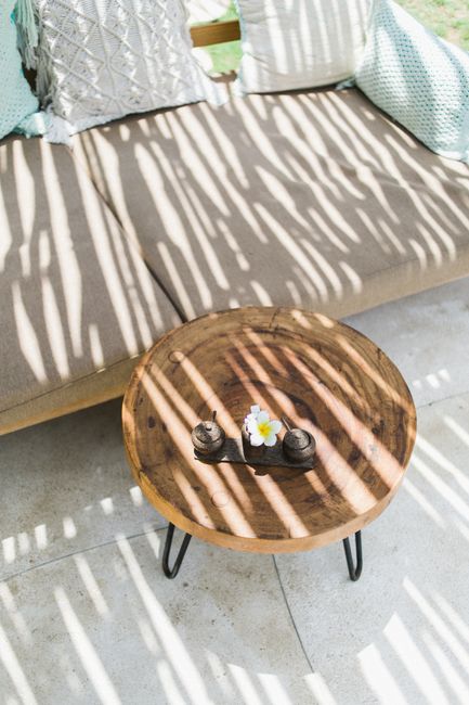 From above of long thin shadows on comfortable sofa and small round table in daytime