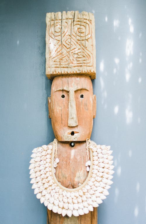 Old wooden statuette in necklace