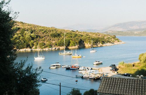 Free High angle of yachts in lagoon of sea with green hills in morning haze Stock Photo