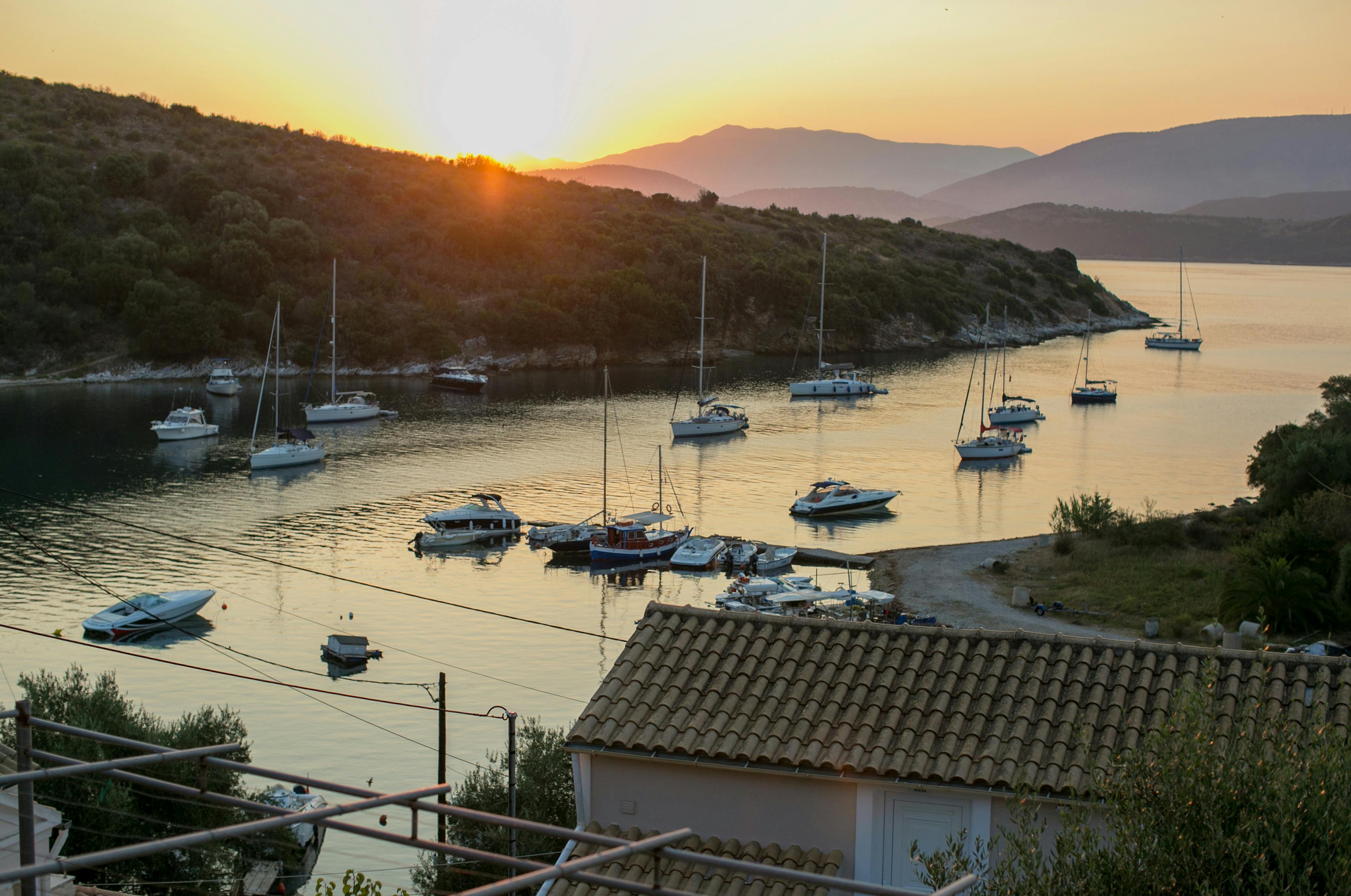 calm sea bay with boats in sunset