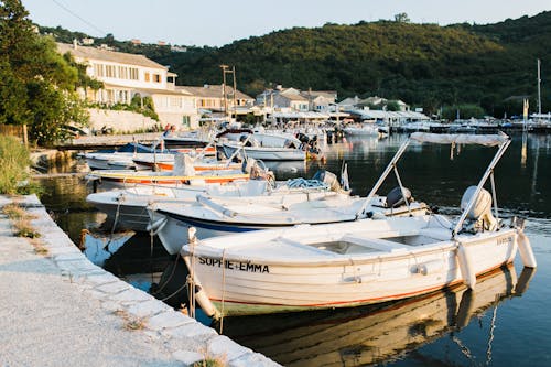 Sailboats at stone port of small town