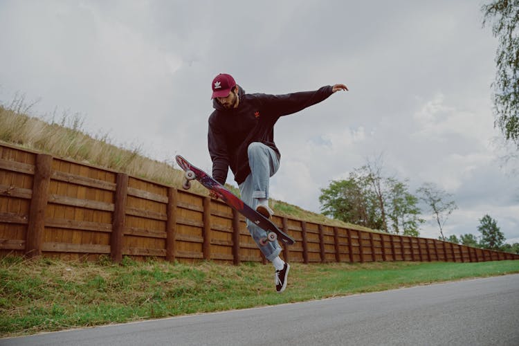 Man In Black Jacket Riding Skateboard