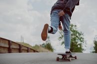 有人在户外平坦的道路上穿着休闲装骑长板