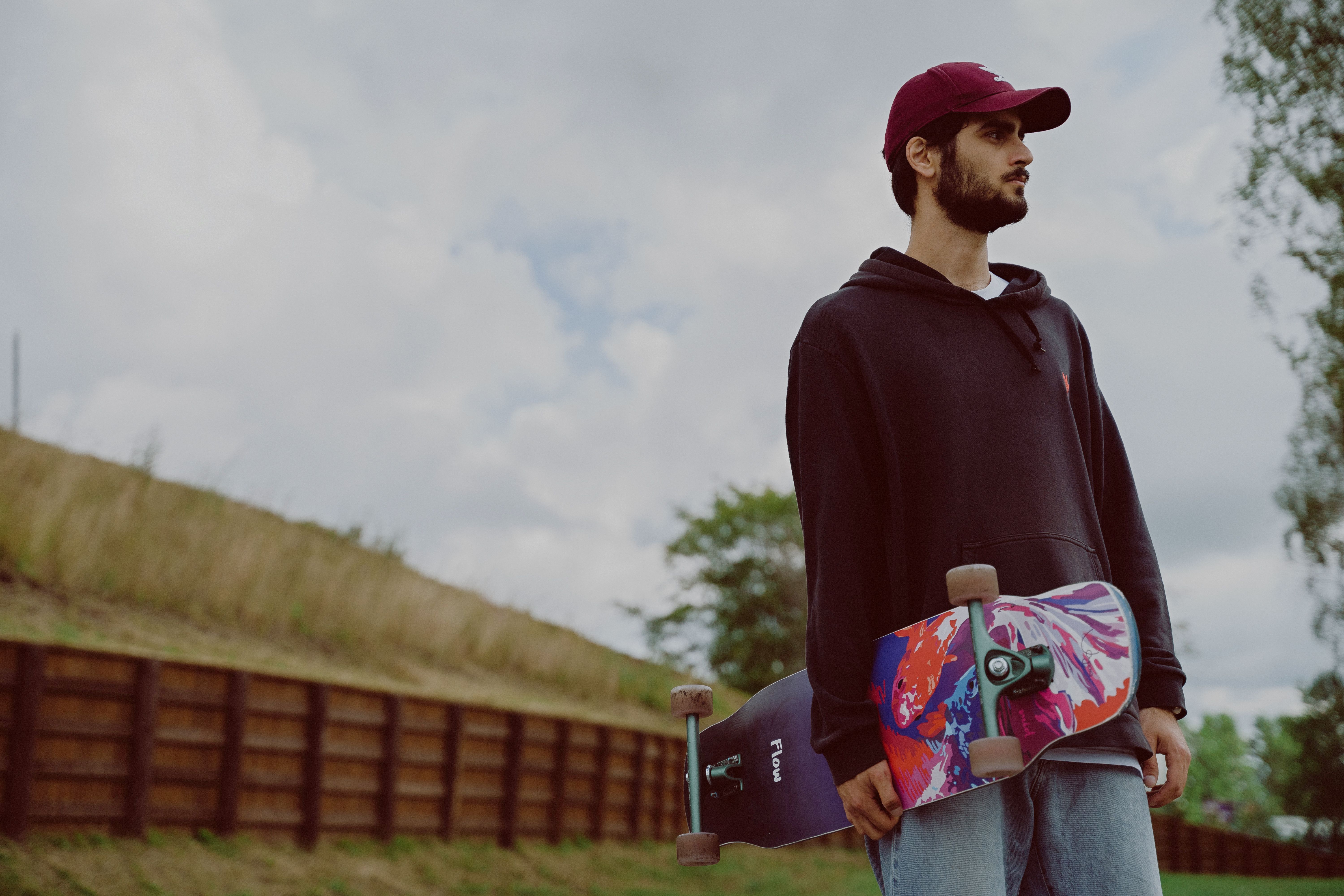 A researcher comparing Cockfight Skateboards references across a laptop, notebook, and Houston skate map