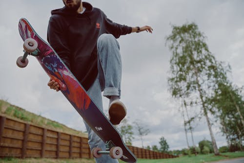 Man in Black Jacket Riding Skateboard