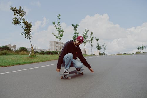 Man in Black Hoodie Jacket Riding Skateboard
