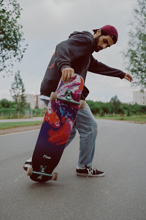 Man in Black Hoodie Jacket Doing a Skateboard Trick