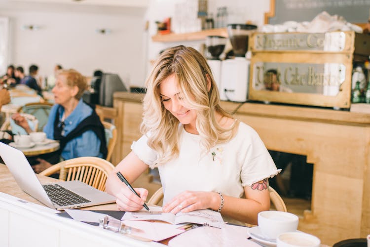 Woman Drawing An Art On A Book