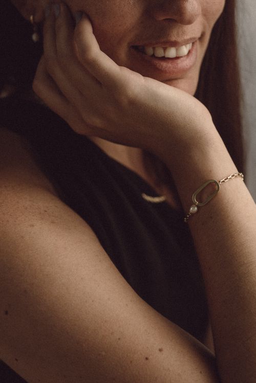 Free Close-up of a woman showcasing a chic bracelet with a warm, intimate vibe. Stock Photo