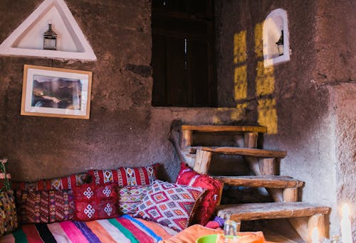 Room with stone walls and colorful sofa