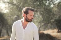 Man in White Dress Shirt Standing Near Green Trees