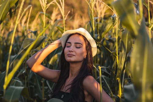 Woman Wearing a Hat Posing on Corn Field