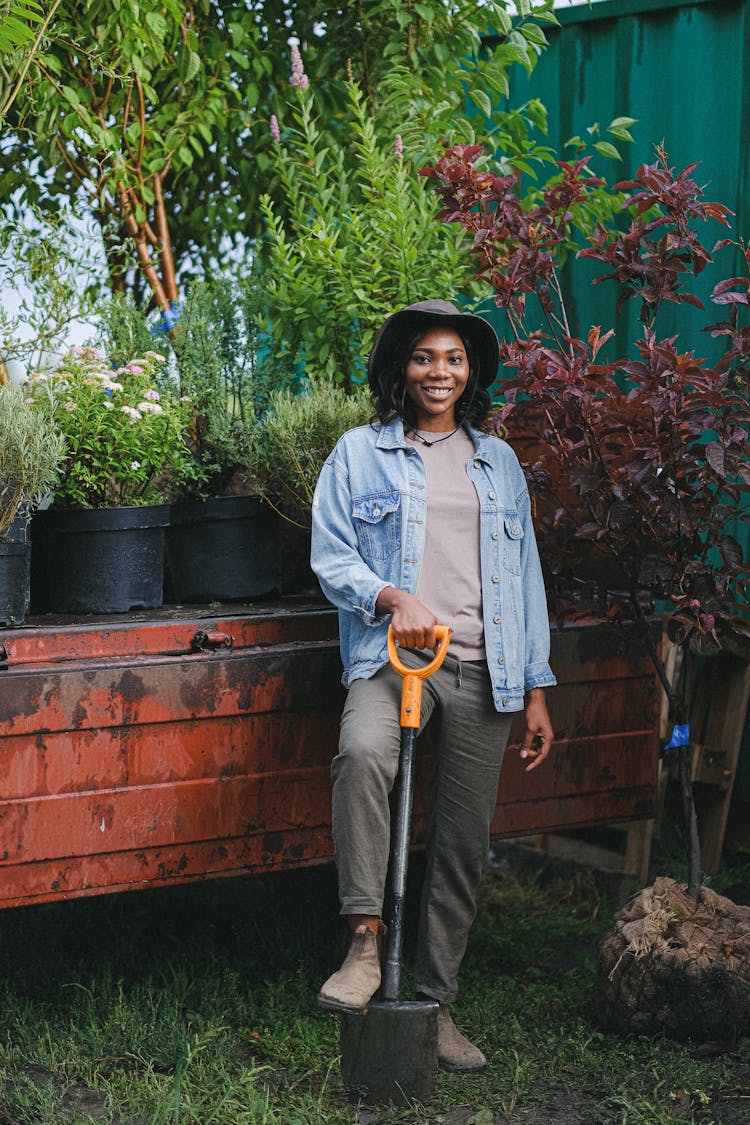 Woman In Denim Jacket Holding A Shovel