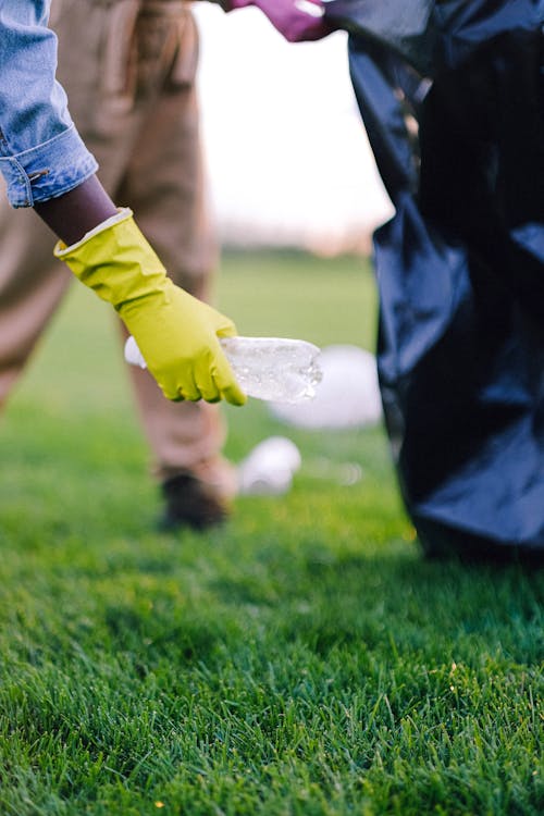 
A Close-Up Shot of a Person Picking up a Water Bottle