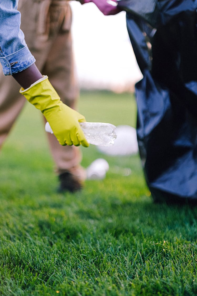 
A Close-Up Shot Of A Person Picking Up A Water Bottle