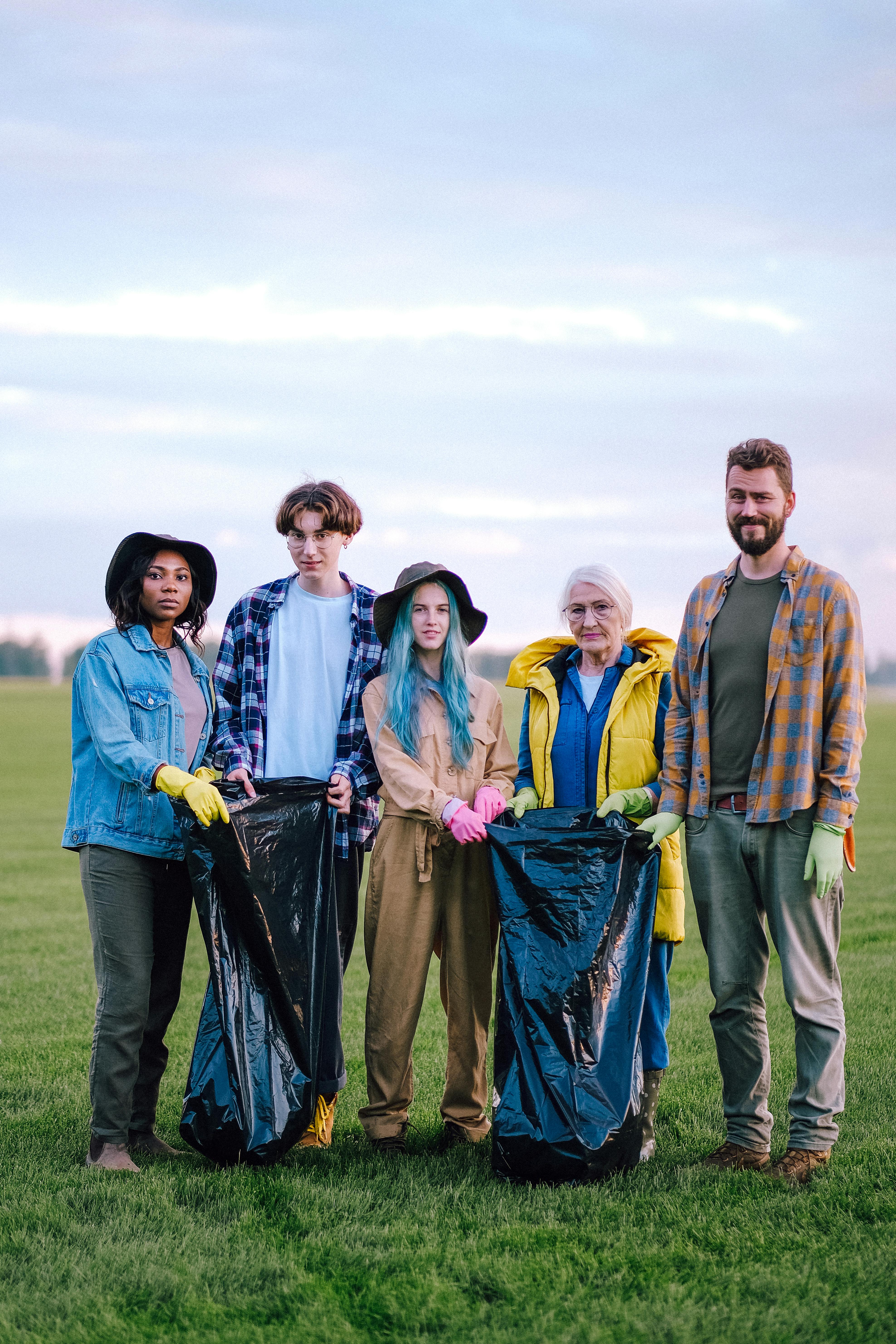 3 Women And 2 Men Standing On Green Grass Field · Free Stock Photo