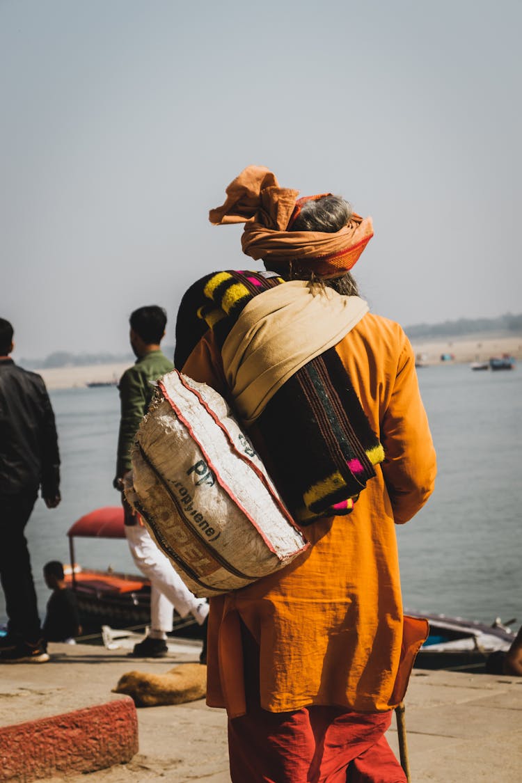 Unrecognizable Hindu Man In Traditional Apparel Near River