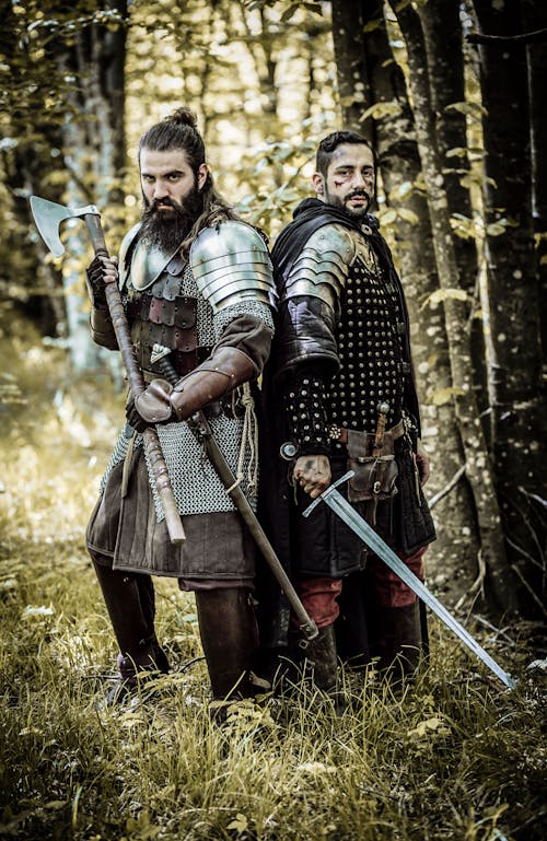 Free Warriors Standing in the Forest while Holding Weapons Stock Photo
