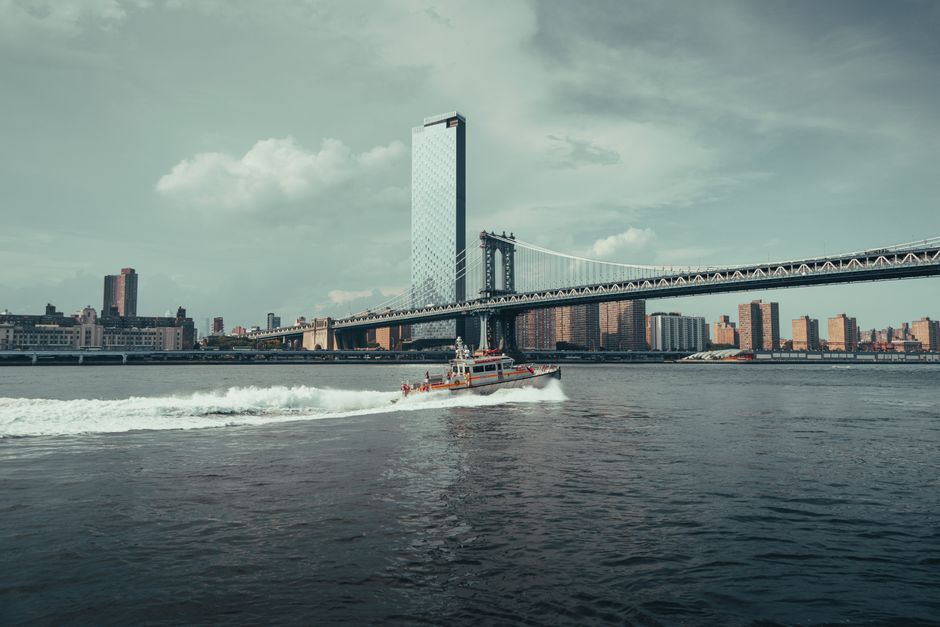 Stunning New York City Sunset or Daytime Sightseeping Cruise Review: A Complete Guide Review 2026 - A boat sails across the river with a stunning view of New York City skyline and bridge.