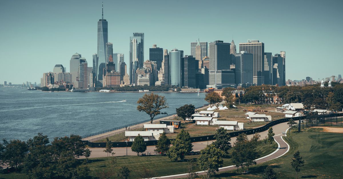 Aerial view of Manhattan skyline with skyscrapers and river in New York City.