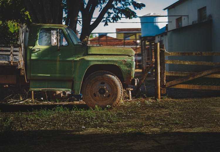 Old Pickup Truck Parked On Yard Near House