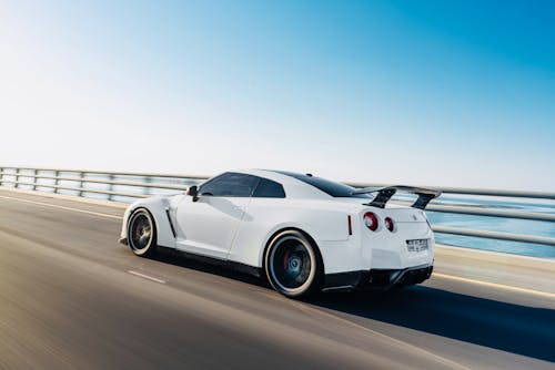 A Fast Moving White Car on the Road