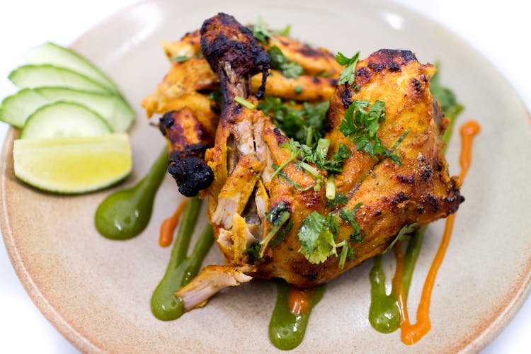 Fried Chicken With Green Sauce On White Ceramic Plate