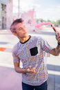 Stylish man with artificial smoke on pavement