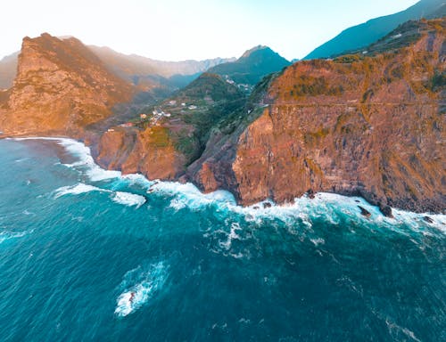 

An Aerial Shot of a Rocky Mountains by the Ocean