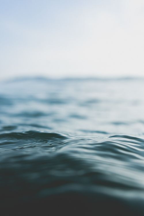 Free Blurred waves under a soft sky, capturing tranquility in the sea off Portugal's coast. Stock Photo