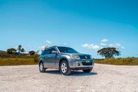 Blue Bmw X 6 on Brown Field Under Blue Sky
