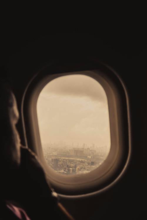 Person Sitting Near an Airplane Window