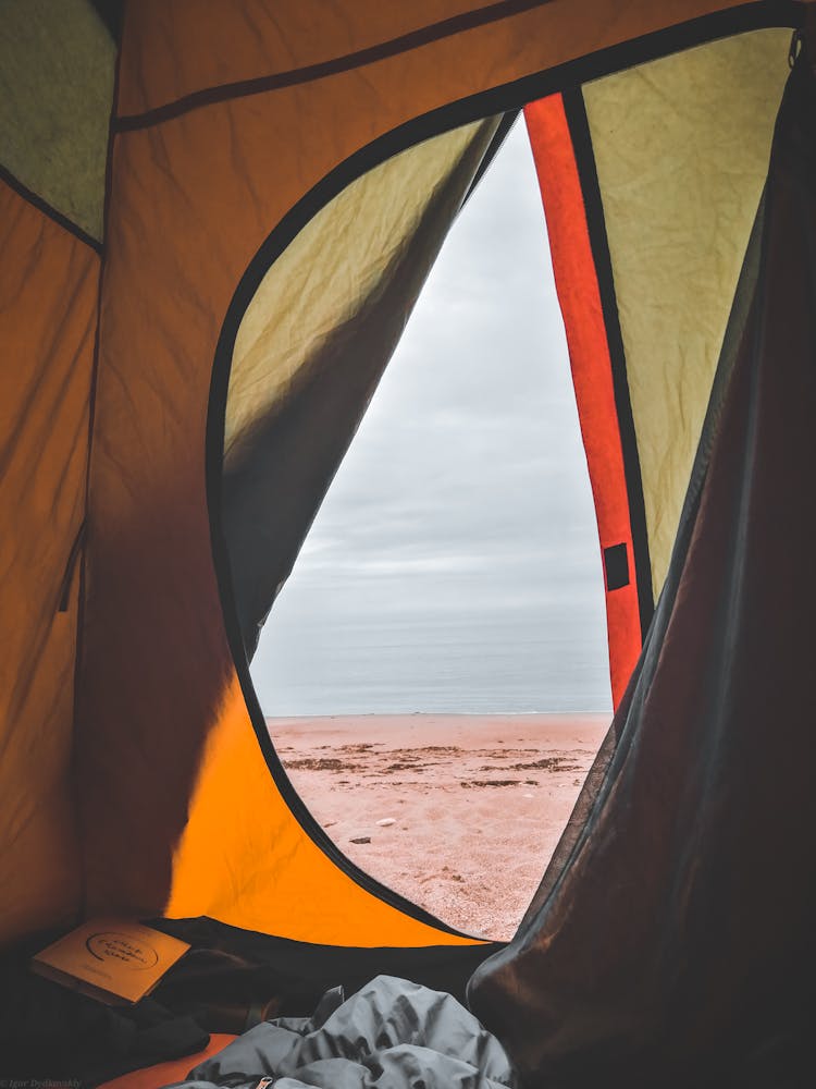 Sandy Beach Seen Through An Open Tent