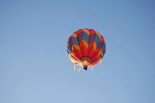Free Colorful Hot Air Balloon Flying Against Blue Sky Stock Photo