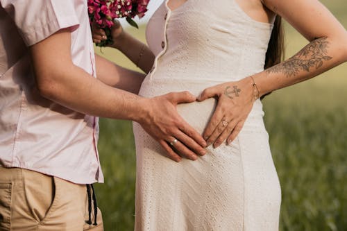 Man Touching a Pregnant Woman's Belly