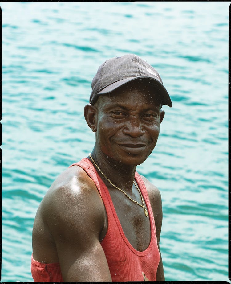 A Man In Red Tank Top Wearing Gray Cap