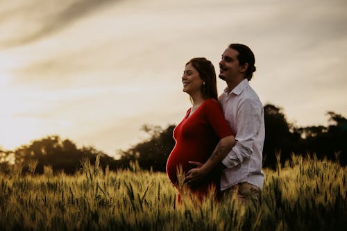 Man Hugging Pregnant Woman From Behind 