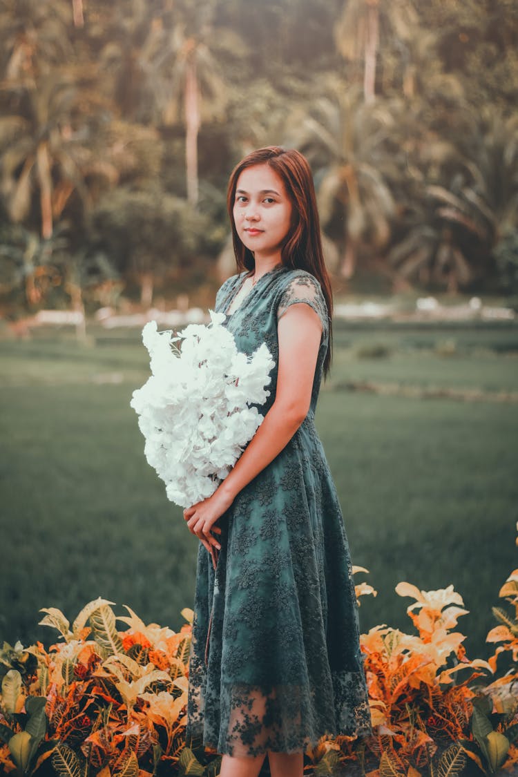 Asian Woman With Bunch Of Flowers