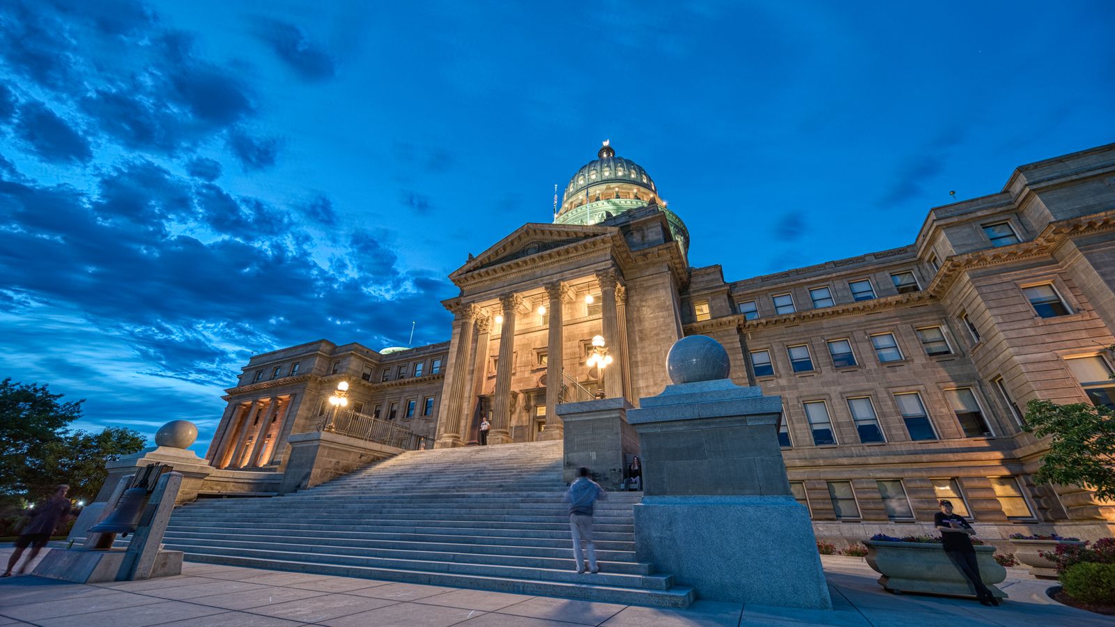 Exterior of historic classic palace with dome and decorative pillars near spacious staircase at dark peaceful night
