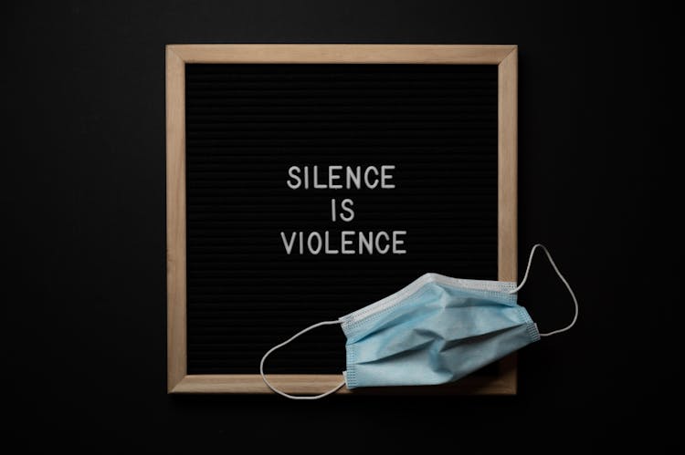 Composition Of Framed Silence Is Violence Inscription On Black Background With Face Mask