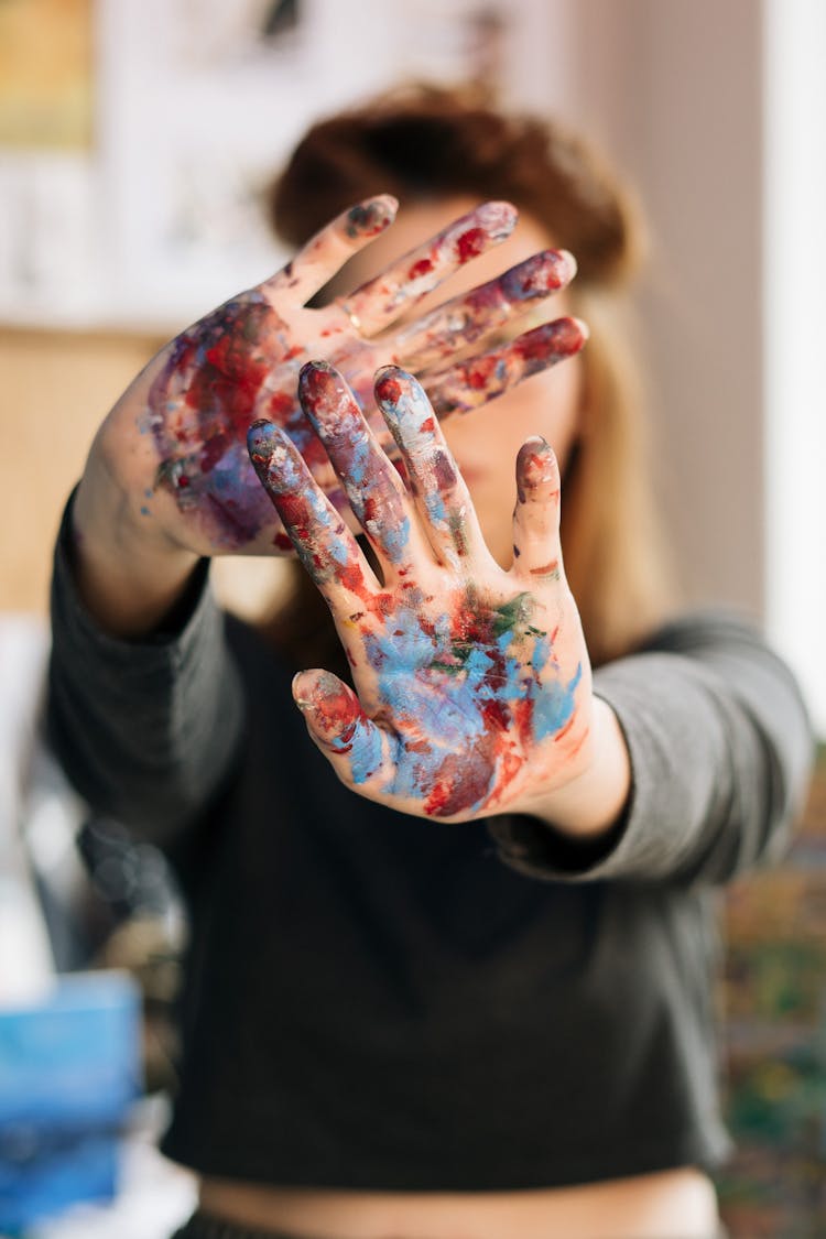 A Person With Paint On Hands